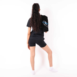 Woman in black athletic outfit with Cyber X logo, stretching on white background